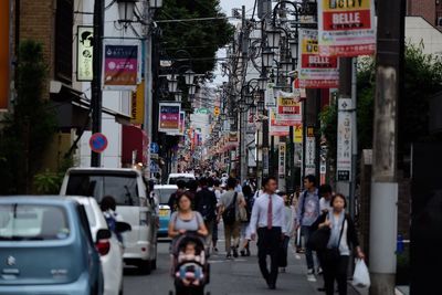 People walking on street in city