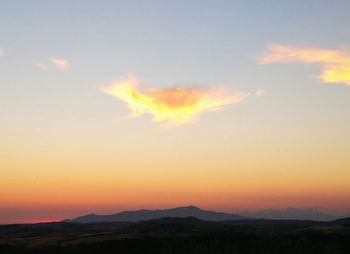 Scenic view of silhouette mountains against sky at sunset