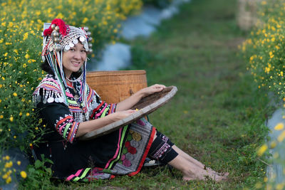 Young woman sitting on field