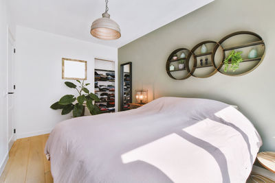 Low angle view of electric lamp on bed at home