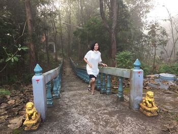 Man standing by plants in forest