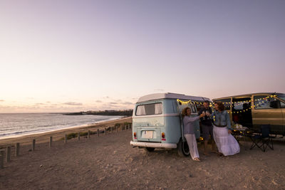 Cars on beach against clear sky