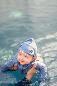 Portrait of cute boy in water