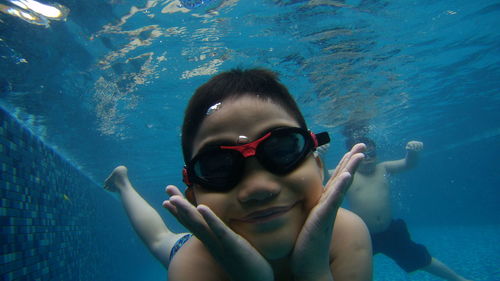 Portrait of boy swimming in pool