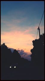 Silhouette of built structure at sunset