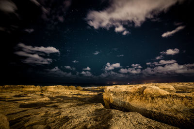 Scenic view of landscape against sky at night