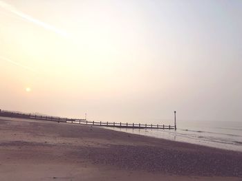 Scenic view of beach against sky during sunset