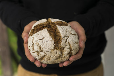 Close-up of man holding leaf