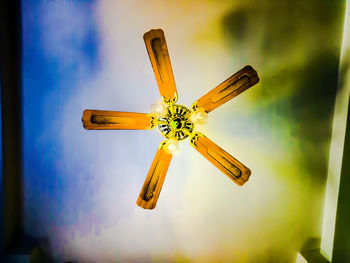Low angle view of yellow flower hanging on ceiling