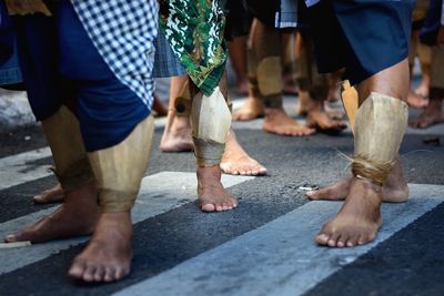 Low section of people standing on street during carnival