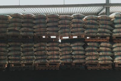 Stack of coffee beans in burlap sacks at warehouse