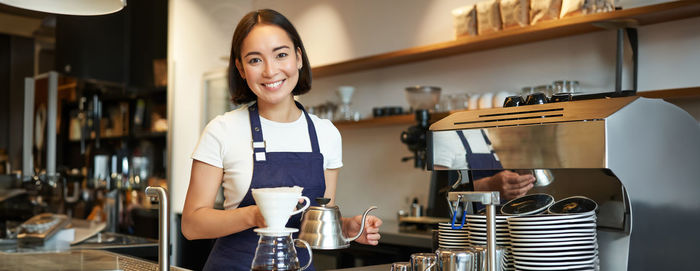 Portrait of woman standing in cafe