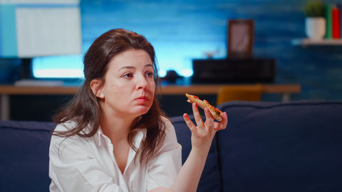 Portrait of young woman smoking cigarette