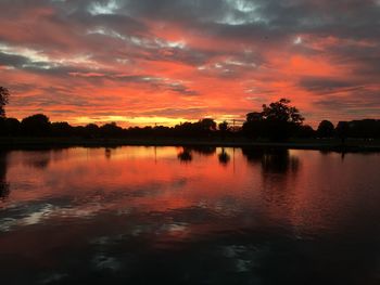 Scenic view of lake against romantic sky at sunset