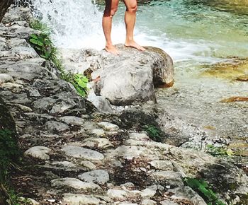 Low section of man standing on rock