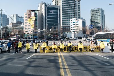 People on city street against modern buildings