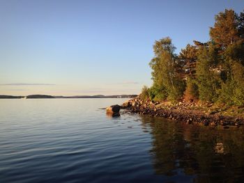 Scenic view of calm lake against clear sky