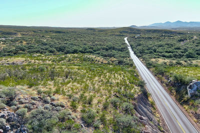 High angle view of road amidst land against sky