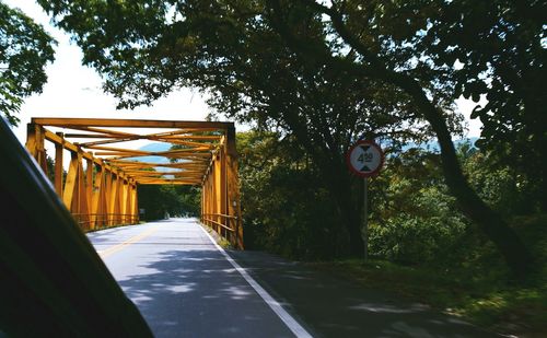 Road amidst trees against sky