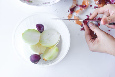 Midsection of person preparing food in bowl on table