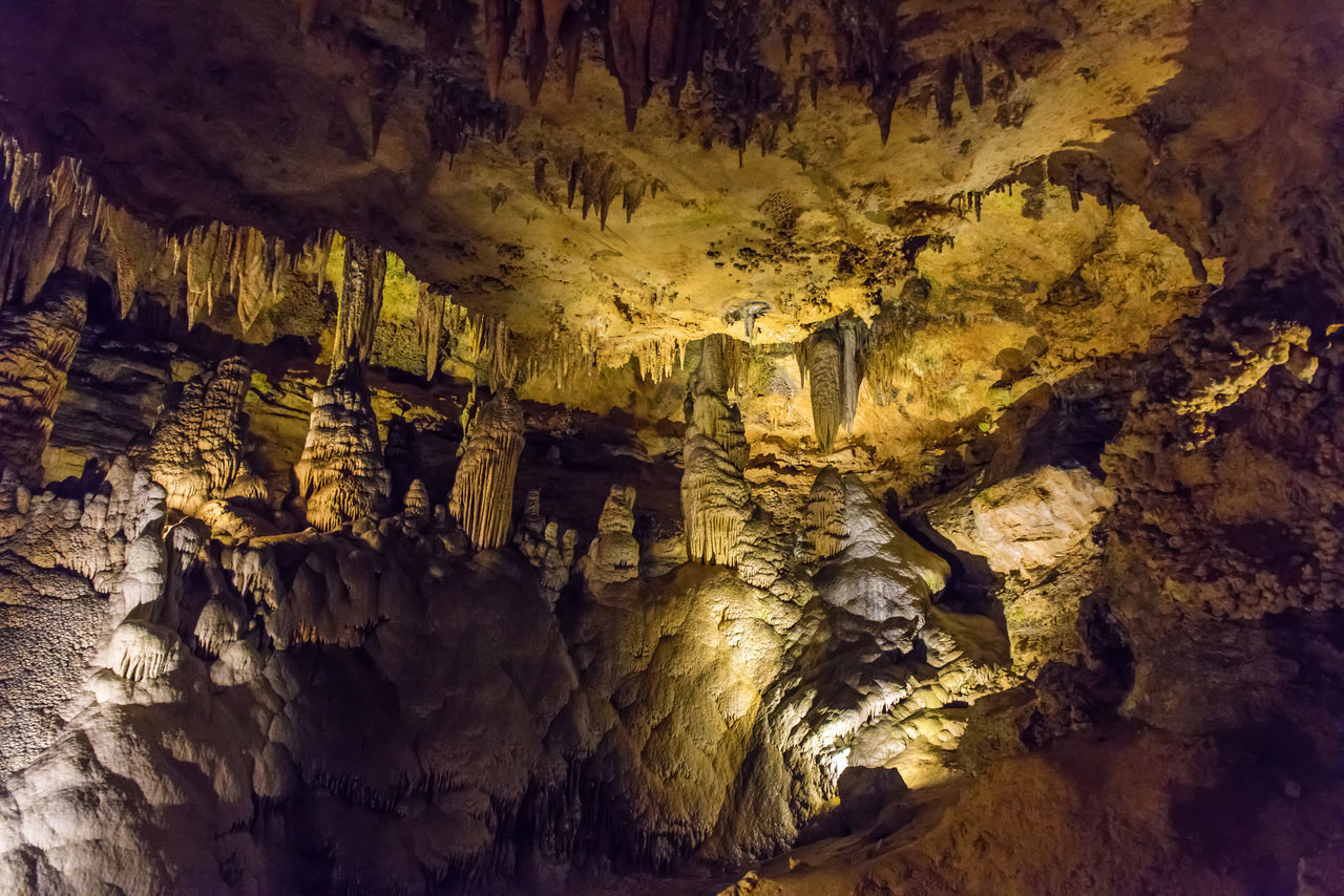 VIEW OF ILLUMINATED CAVE IN CANYON