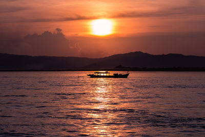 Scenic view of sea against orange sky