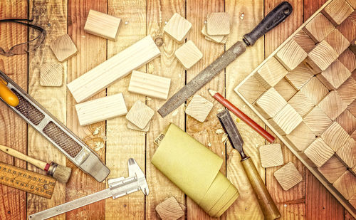 Close-up of work tools on wooden table