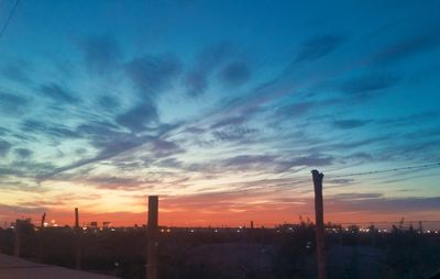 Silhouette buildings against sky during sunset