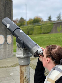 Portrait of woman looking through a telescope 