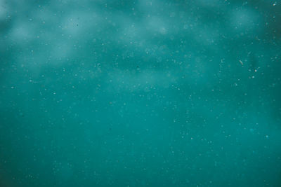 Full frame shot of raindrops on blue sky