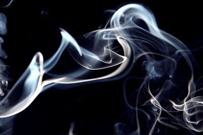 Close-up of smoke over abstract background