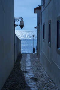 Walkway amidst sea against sky