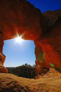 Rocky arch against clear sky