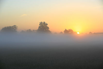 Scenic view of field against sky during sunset