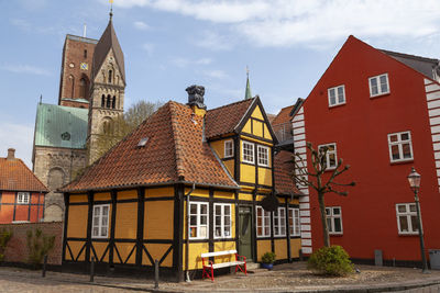 Residential buildings in town against sky