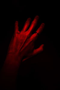 Close-up of human hand against black background