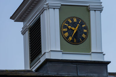 Low angle view of clock tower against sky