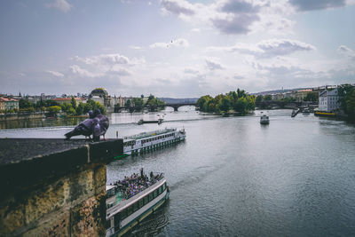 People by river against sky