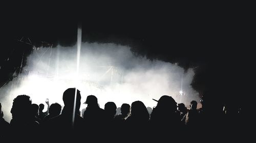 Silhouette people at music concert