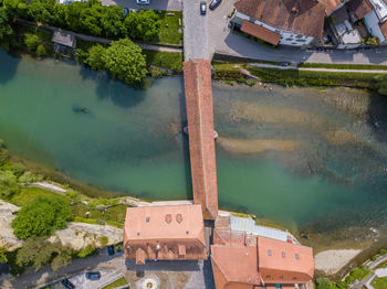 High angle view of covered bridge over river in city