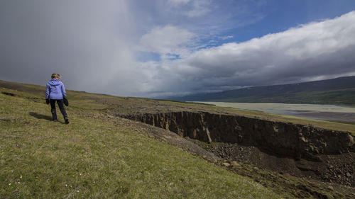 Rear view of people standing on landscape