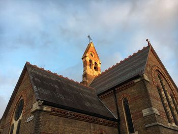 Low angle view of clock tower against sky