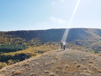 Man standing on mountain against sky