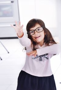 Portrait of girl in eyeglass standing on floor