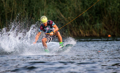 Full length of man jumping in water