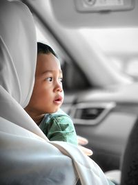 Young woman sitting in car