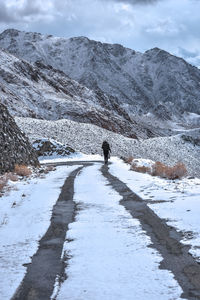 Man on snowcapped mountain against sky