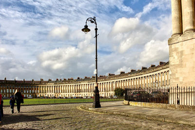 People walking on street amidst buildings in city