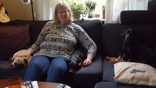 Woman sitting on sofa at home