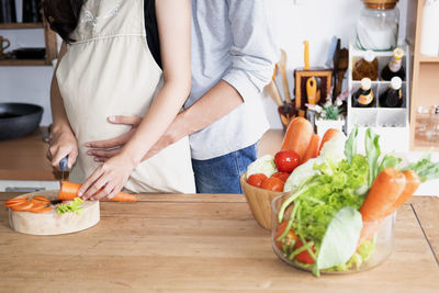 Midsection of woman preparing food on table